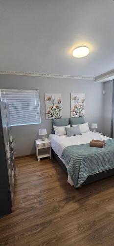 a bedroom with a large bed and a window at Namaqua Bella Vista in Springbok