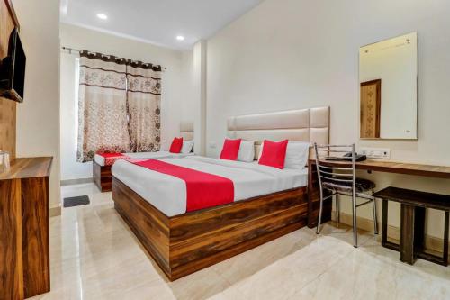 a bedroom with a bed with a desk and a keyboard at Hotel Bliss Inn in Jāmb
