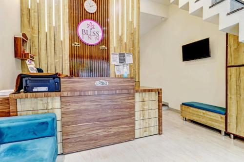 a restaurant with a counter with blue chairs in a room at Hotel Bliss Inn in Jāmb