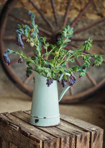 a white vase with flowers in it on a table at Pure Gardères in Monlezun