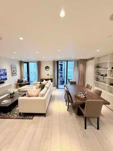 a large living room with a table and a couch at Central London Designer Home w Game Room and AC in London