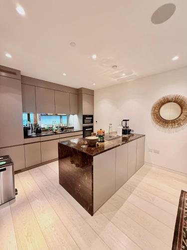 a kitchen with a large island in the middle at Central London Designer Home w Game Room and AC in London