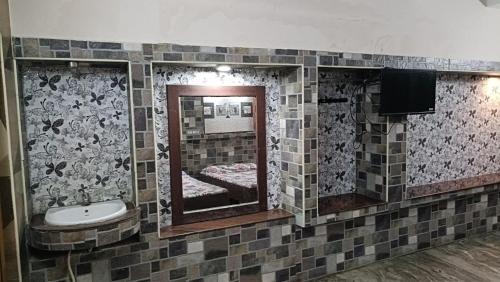 un baño con lavabo y espejo en Hotel Rehoboth, en Kanyakumari
