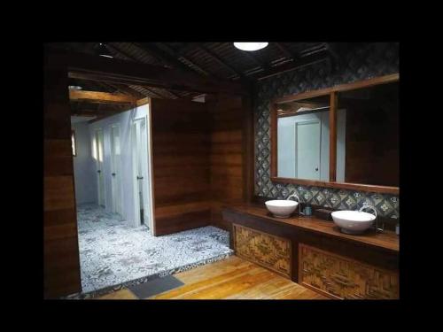 a bathroom with two sinks and a mirror at International Cruisers Seafront Beach Resort and Farm in San Agustin