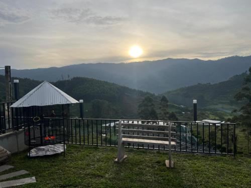 a view of the mountains with the sun in the sky at Orange Valley Farm Resort in Munnar