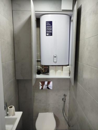 a small bathroom with a toilet and a sink at Comfort MD in Chişinău