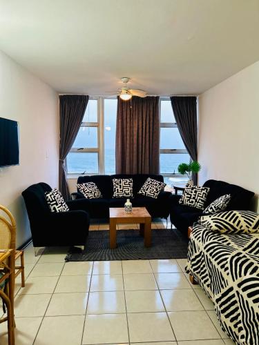 a living room with a couch and a table at Coastal Bliss Retreat Peacehaven 207 in Scottburgh