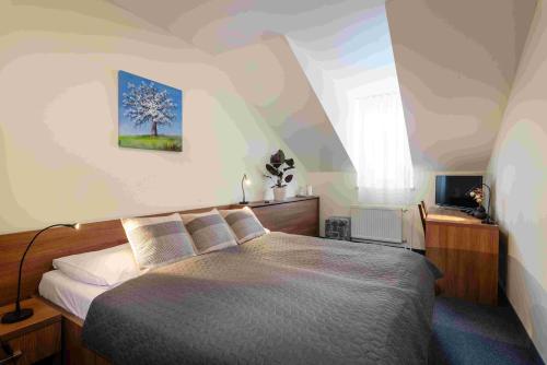 a bedroom with a large bed in a attic at Horský hotel Remata in Ráztočno