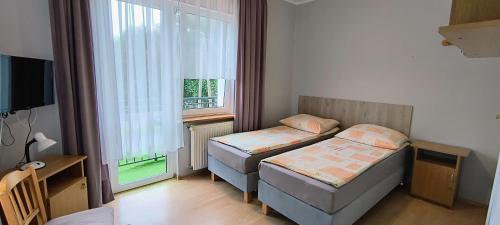 Postel nebo postele na pokoji v ubytování Słoneczny Brzeg