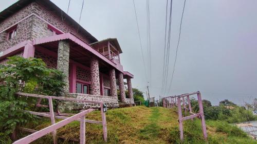 a pink house on the side of a hill at PINK HOUSE DORMENTRY Vattakanal in Kodaikānāl