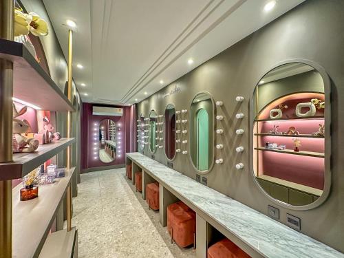 a dressing room with a row of mirrors at ARNI HER Ladies Hotel - Female Only in Bangkok