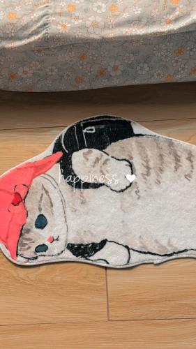 a cat laying on a floor under a bed at Cana Garden House 1 โฮมสเตย์ in Ban Khok