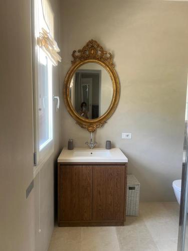 a bathroom with a sink and a mirror at Villa Heron Sicily in Noto