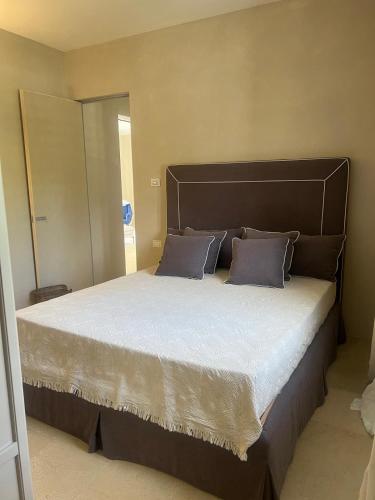 a bedroom with a large bed with two pillows at Villa Heron Sicily in Noto