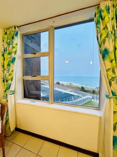a window in a room with a view of the ocean at Coastal Bliss Retreat Peacehaven 207 in Scottburgh