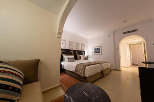 a bedroom with a bed and a couch at Rose Aqua Park Hotel in Marrakesh