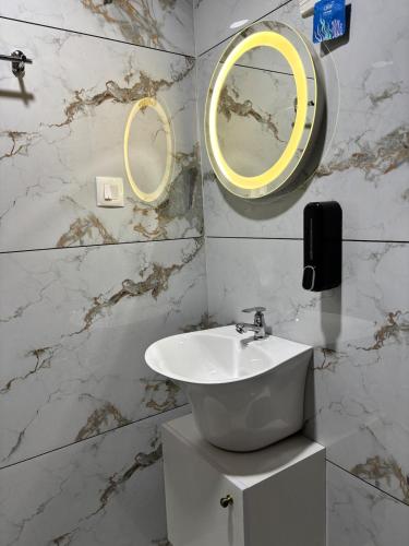 a bathroom with a sink and a mirror at Vadanapilly Beach Villa for 8-10 adults in Irimbranallūr