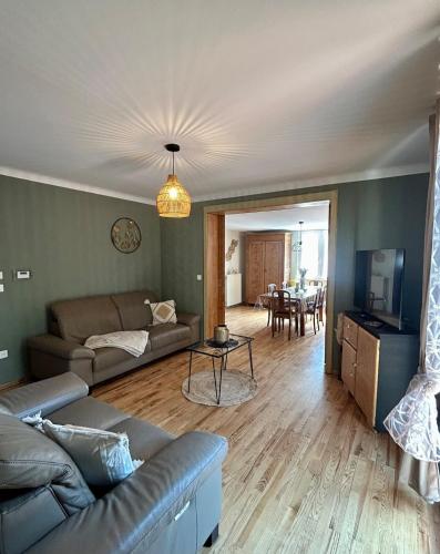 a living room with a couch and a table at le gîte des frangines in Bitche