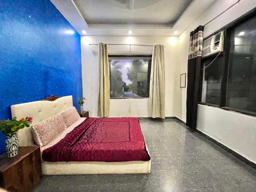 a living room with a bed and a window at Fresh water pool farm Near sec 10 in Gurgaon