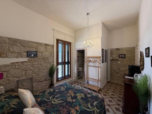 a bedroom with a bed and a stone wall at B&B Porta Verde in Castelbottaccio