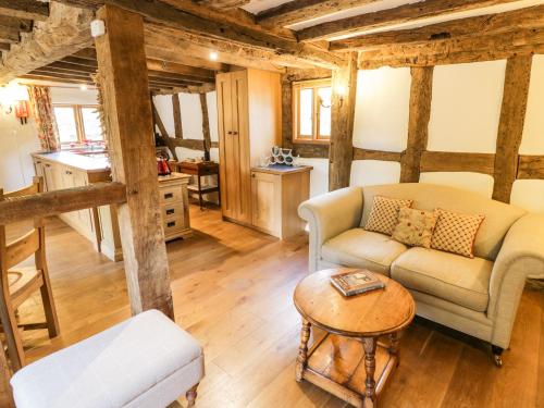 a living room with a couch and a table at Manor Cottage in Church Stretton