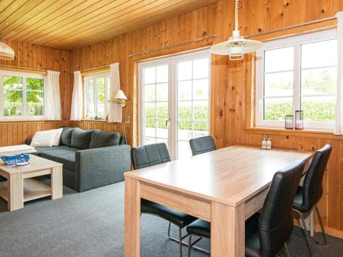 a living room with a table and a couch at Tranquil Cottage near Kvie Lake-By Traum in Ansager