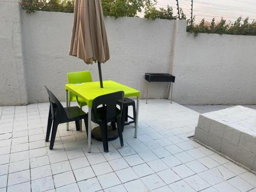 a yellow table and chairs with an umbrella at Tranquil Escape in Bromhof area in Fontainebleau