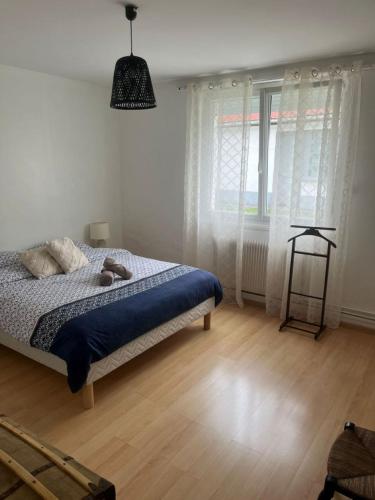 a bedroom with a bed and a large window at Le reflet de la cathédrale in Saint-Omer
