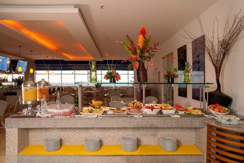 a buffet in a restaurant with plates of food at GHL Hotel Grand Villavicencio in Villavicencio