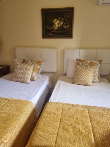 two beds sitting next to each other in a room at Casa Ermida in Pincães