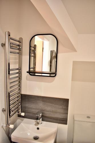 a bathroom with a sink and a mirror at Stylish Modern Flat in Doncaster Centre in Doncaster