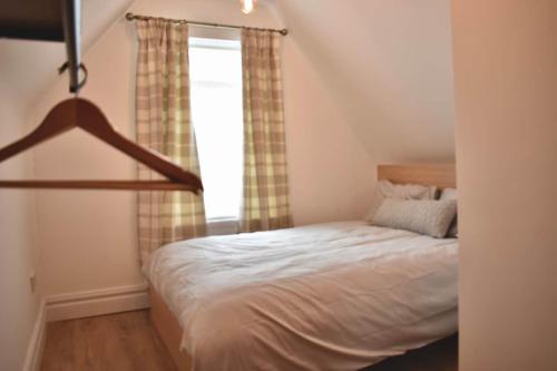 a bedroom with a bed and a window at Stylish Modern Flat in Doncaster Centre in Doncaster