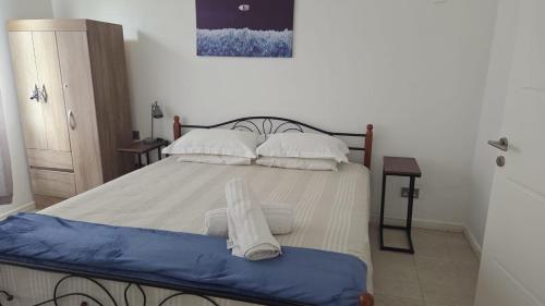 a bedroom with a large bed with two pillows at Coastal View Apartments in Grand Baie