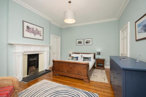 a bedroom with a bed and a fireplace at Banrigh House in Stirling