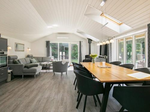 a dining room and living room with a table and chairs at 5 star holiday home in Væggerløse in Bøtø By