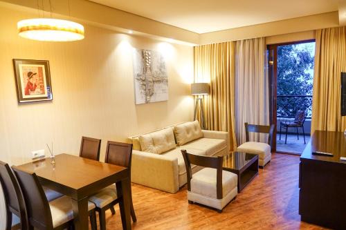 a living room with a couch and a table at Luxury Dreamland Oasis Apartments in Chakvi