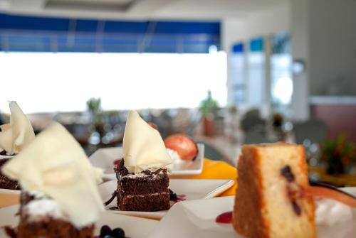 a piece of cake and a piece of cake on a plate at GHL Hotel Grand Villavicencio in Villavicencio