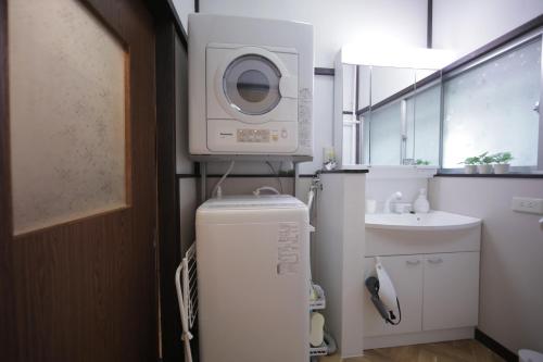 a washing machine on top of a refrigerator in a bathroom at Macchiato SHONAN-Vacation Stay- in Hiratsuka