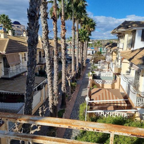 a view of a street with palm trees at Bungalow Pitxintxo Gran Playa in Santa Pola