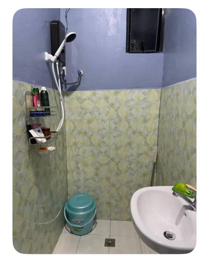 a small bathroom with a sink and a shower at E&Z guest house in Sara