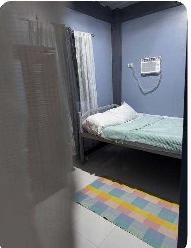 a small room with a bed and a rug at E&Z guest house in Sara