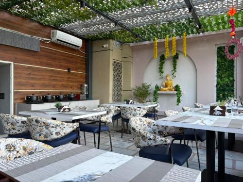 a dining room with tables and chairs at Hotel Mahadev Rishikesh in Rishīkesh