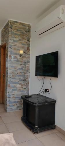 a flat screen tv on a wall in a room at Palmera El Sokhna Chalets Families Only in Ain Sokhna