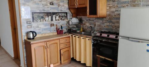 a small kitchen with a sink and a stove at Palmera El Sokhna Chalets Families Only in Ain Sokhna