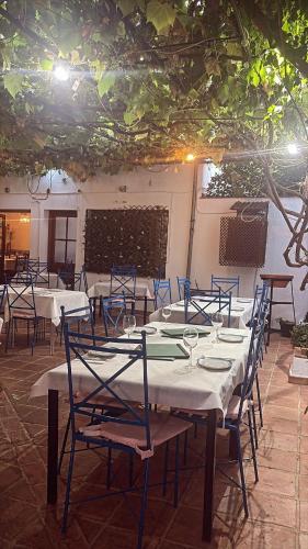 a dining room with tables and chairs in a building at Hospederia Casa de las Piedras in Grazalema