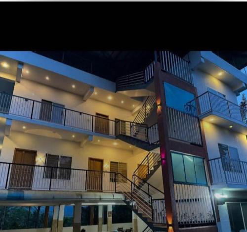 a large building with stairs on the side of it at Spice routes in Vagamon