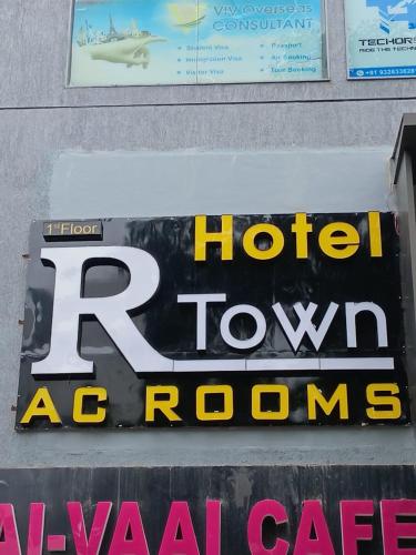 a sign for a hotel room ac rooms at Hotel R Town in Vadodara