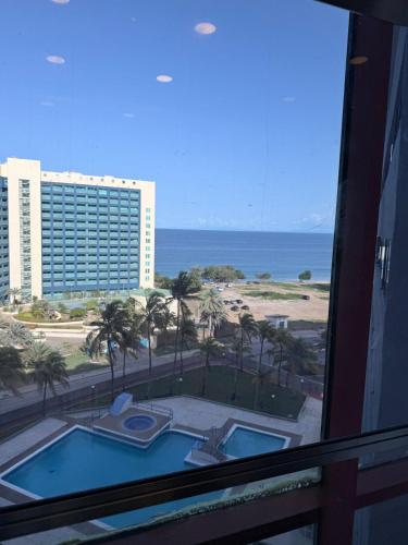 a view of the ocean from a hotel window at Apartamento vista al mar Seaview apartment in Pampatar