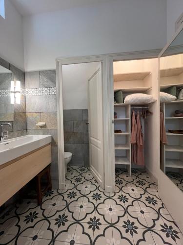 a bathroom with a sink and a toilet at Les Mimosas in Arcachon