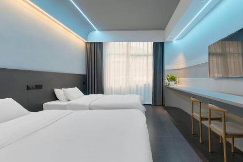 a hotel room with two beds and a bar at Qijianyunshe in Hanqiyu